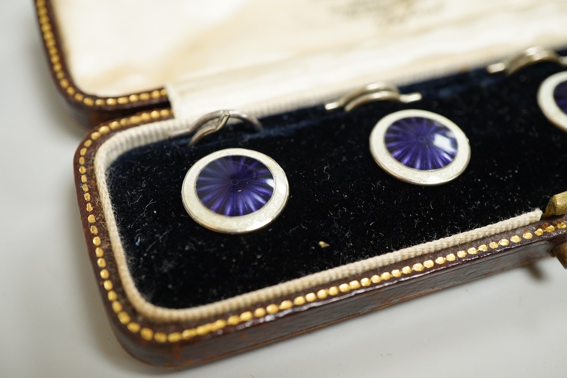 A set of four silver and two colour enamel buttons, by Lawson, Ward & Gammage Ltd, Birmingham, 1910, diameter 12mm, in original gilt tooled leather case by Rowell & Son Ltd of Oxford.